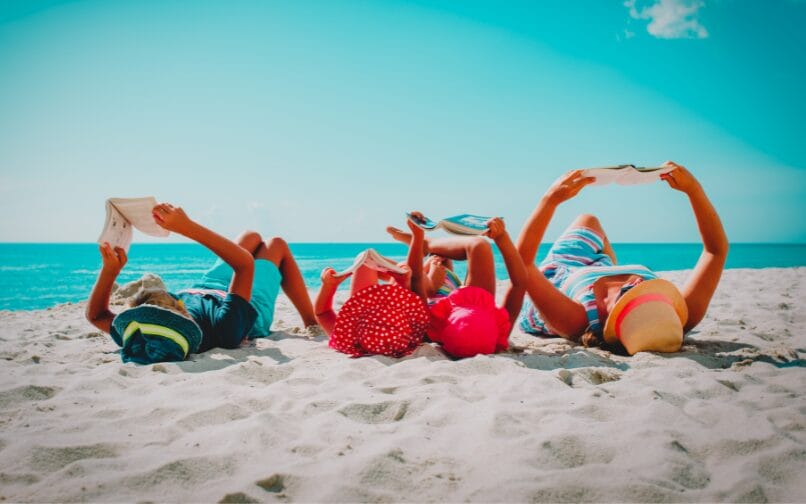 Lecture en famille sur une plage.